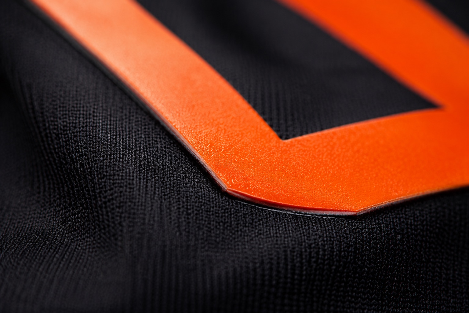 Macro of a DTF print edge showing the thin bonded layer on the fabric surface