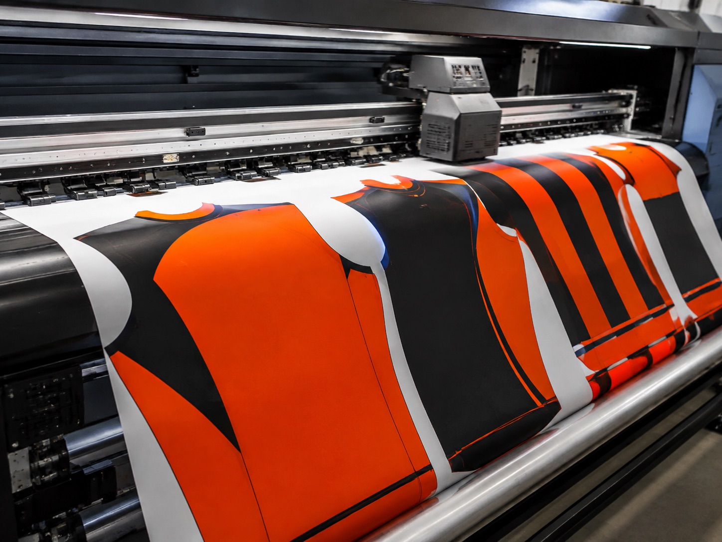 Wide-format sublimation printer laying ink onto transfer paper