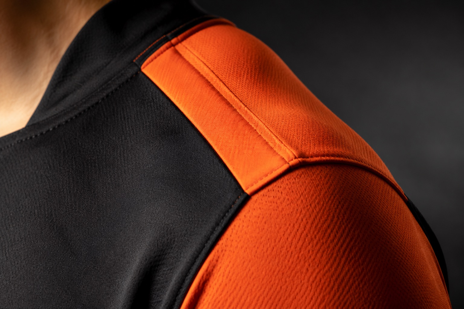 Close detail of a rugby jersey shoulder seam showing bonded reinforced construction