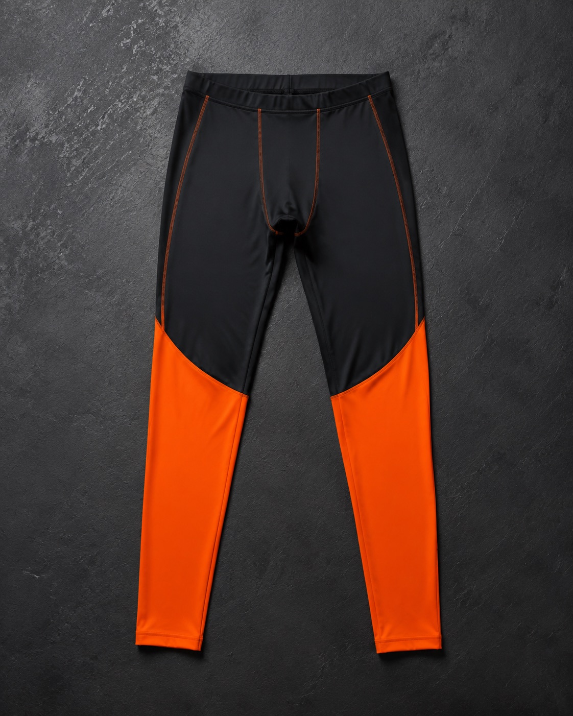 Athletics compression racing tights, flat lay on dark charcoal