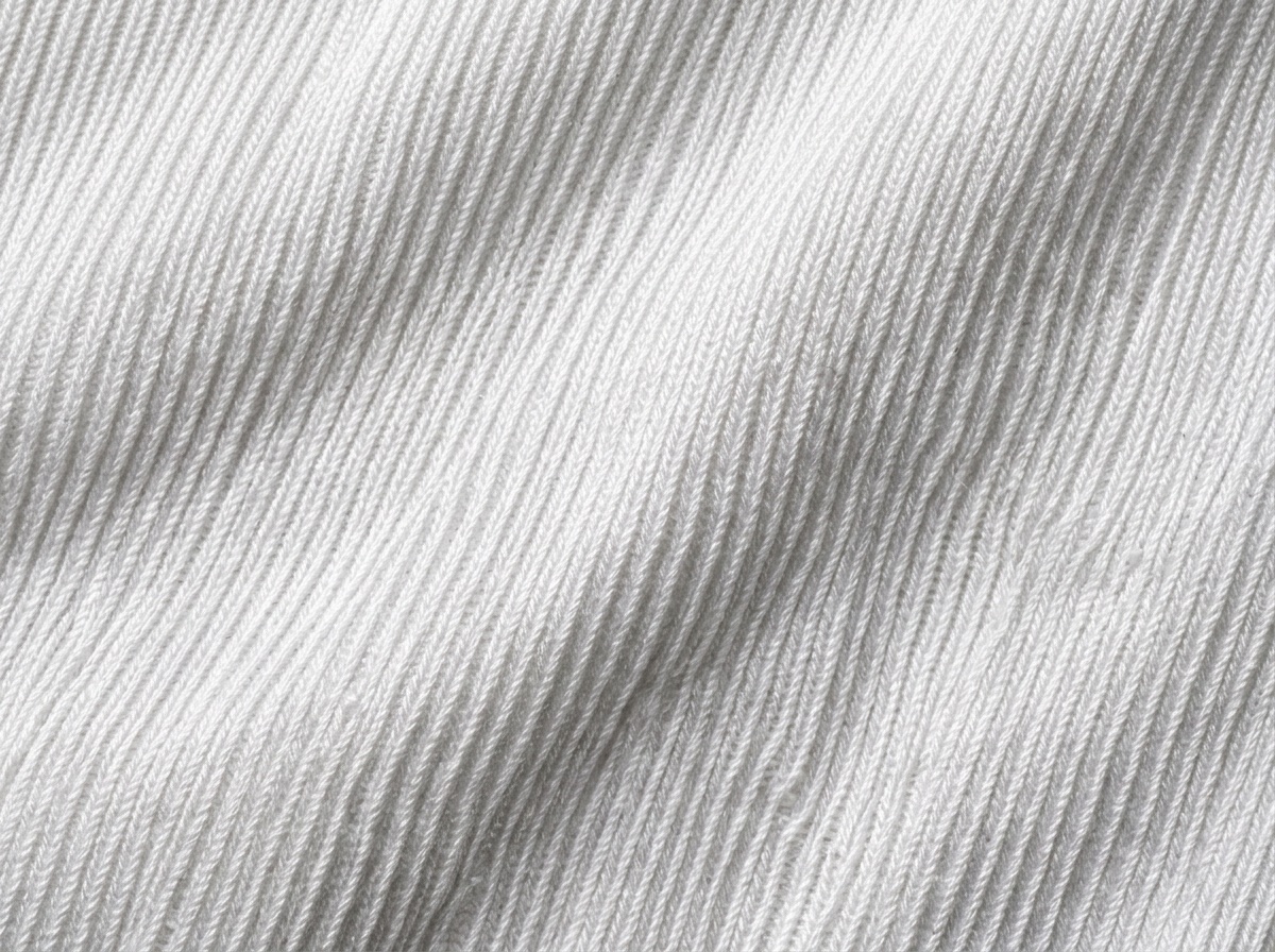 Extreme macro of glossy white dazzle tricot showing its ribbed lustre