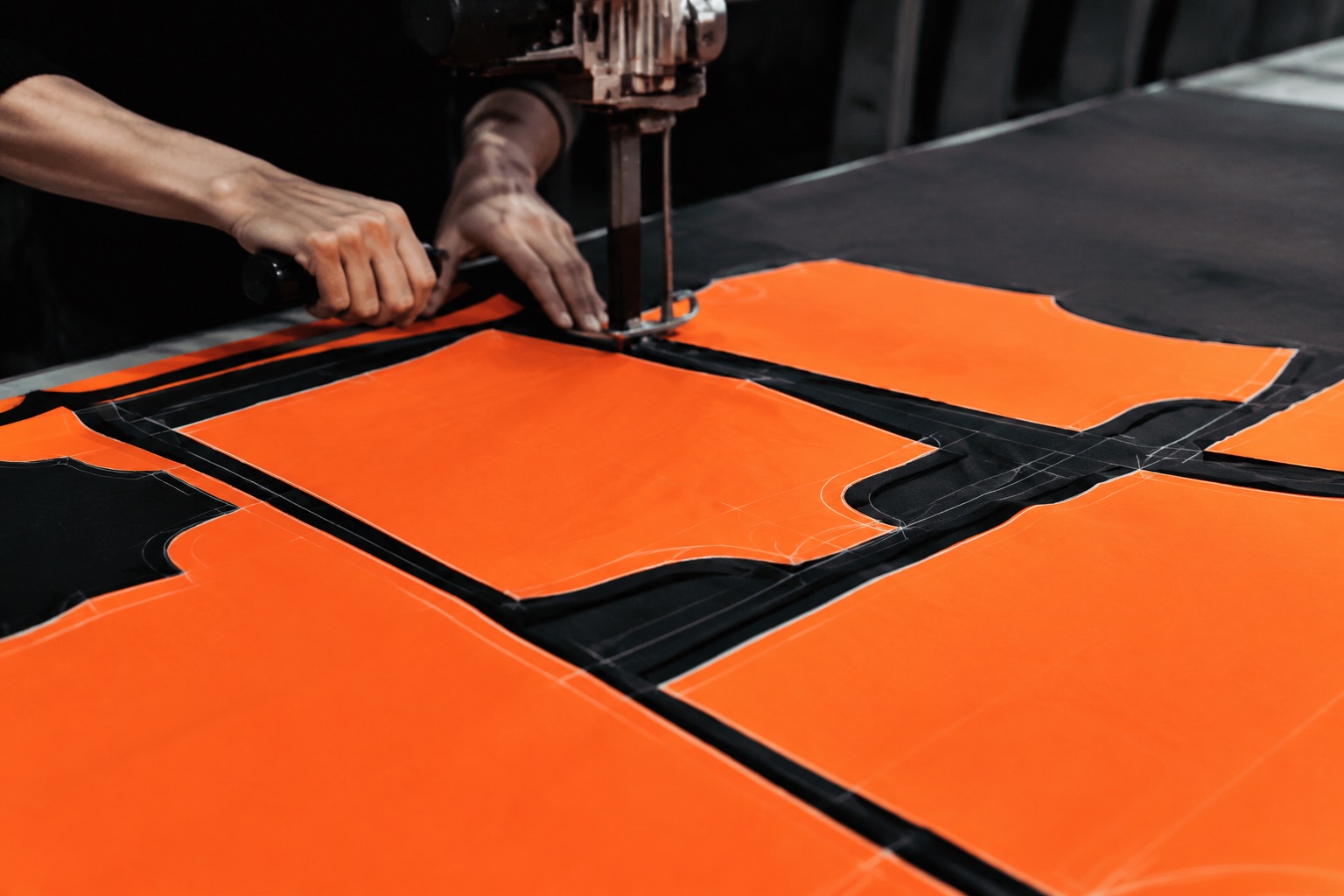 Close detail of a cutting marker showing pattern pieces nested to reduce waste