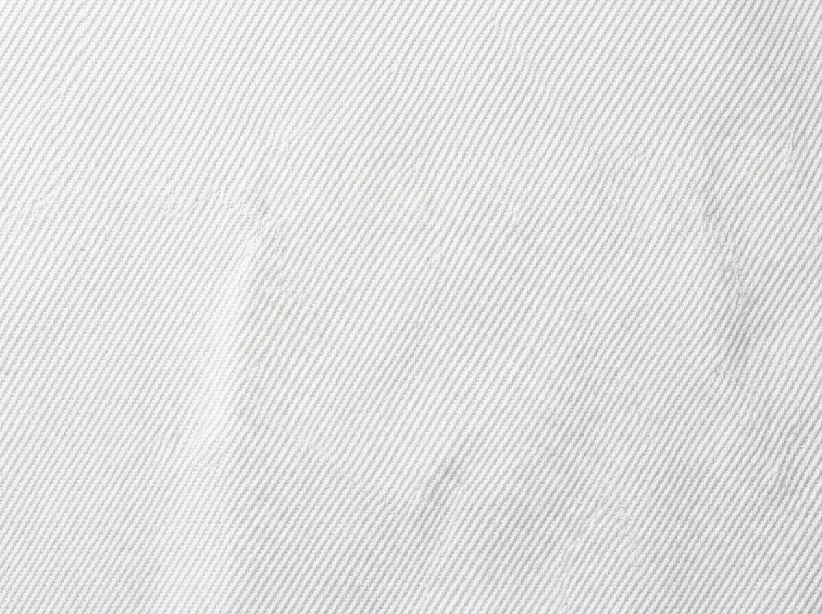 Extreme macro of white poly-viscose cricket twill showing the diagonal weave