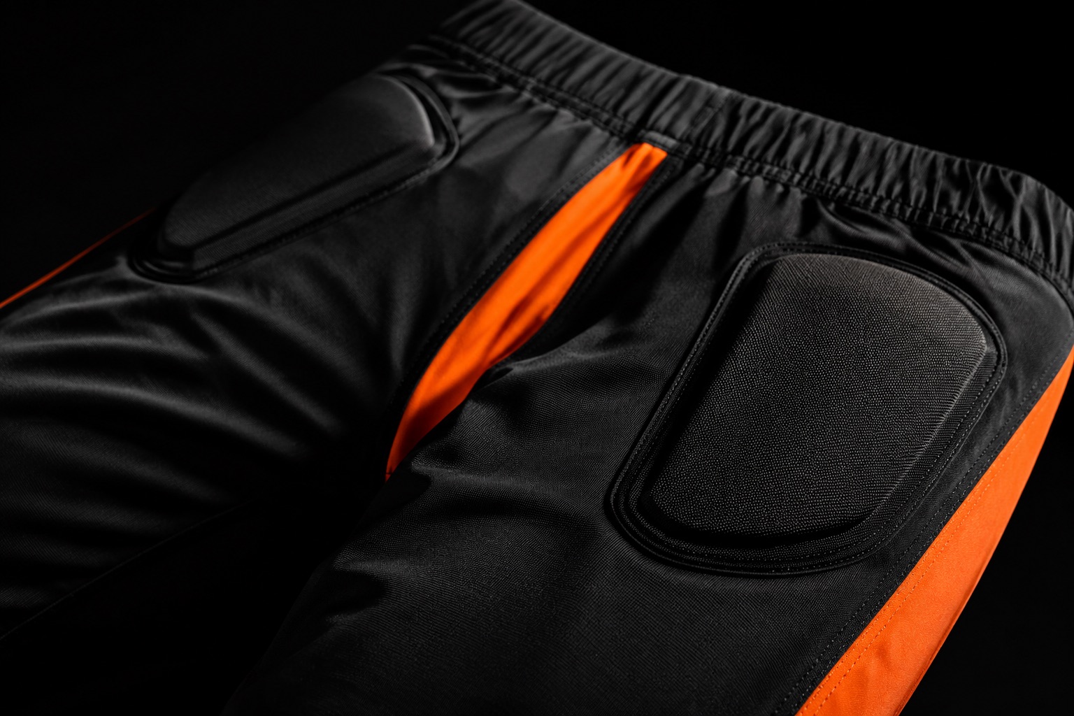 Close detail of integrated football pants showing built-in pad pockets