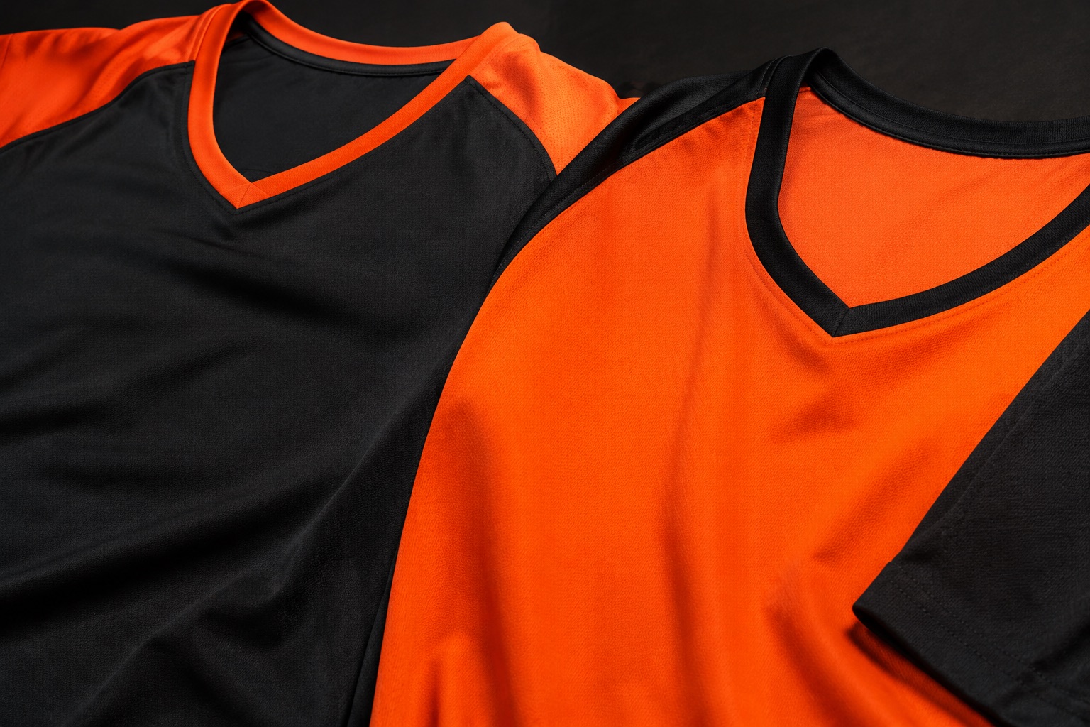 Close detail of a contrasting libero jersey beside a standard team jersey