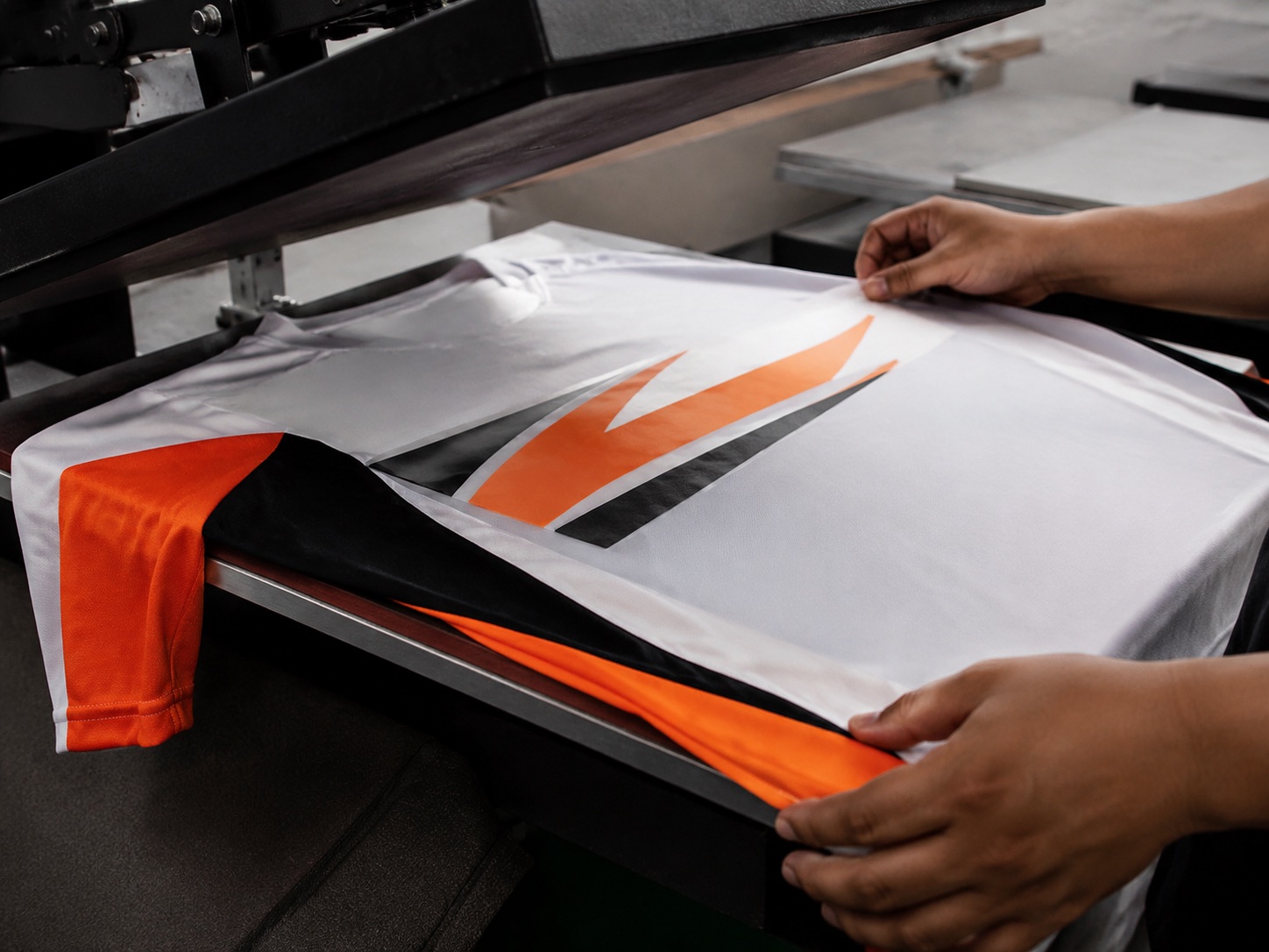 Heat press calendar transferring a sublimation print onto white polyester fabric