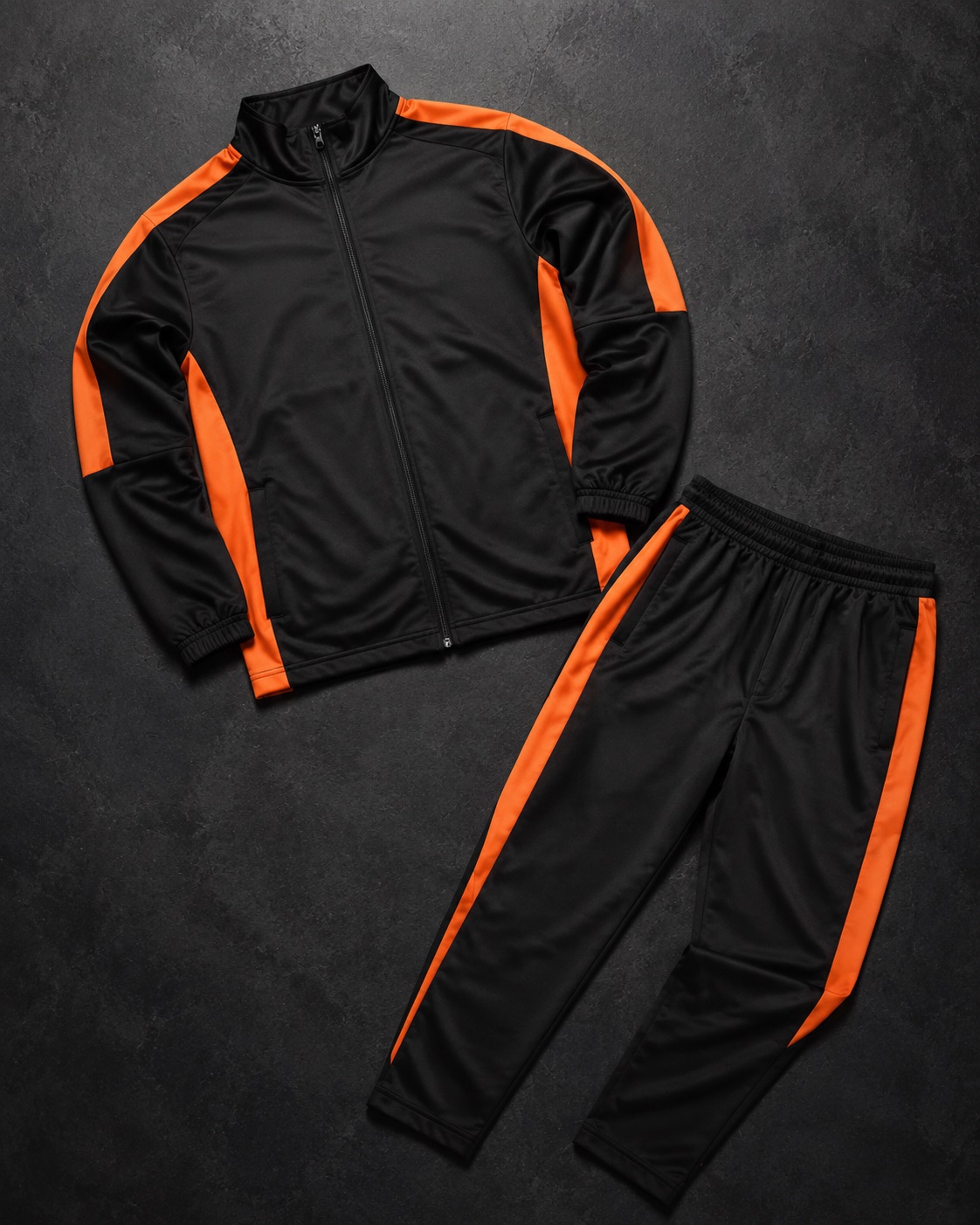 Matching American football travel tracksuit, flat lay on dark charcoal