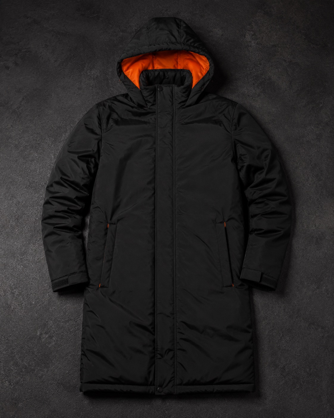 Long-line insulated black football bench coat with orange lining detail