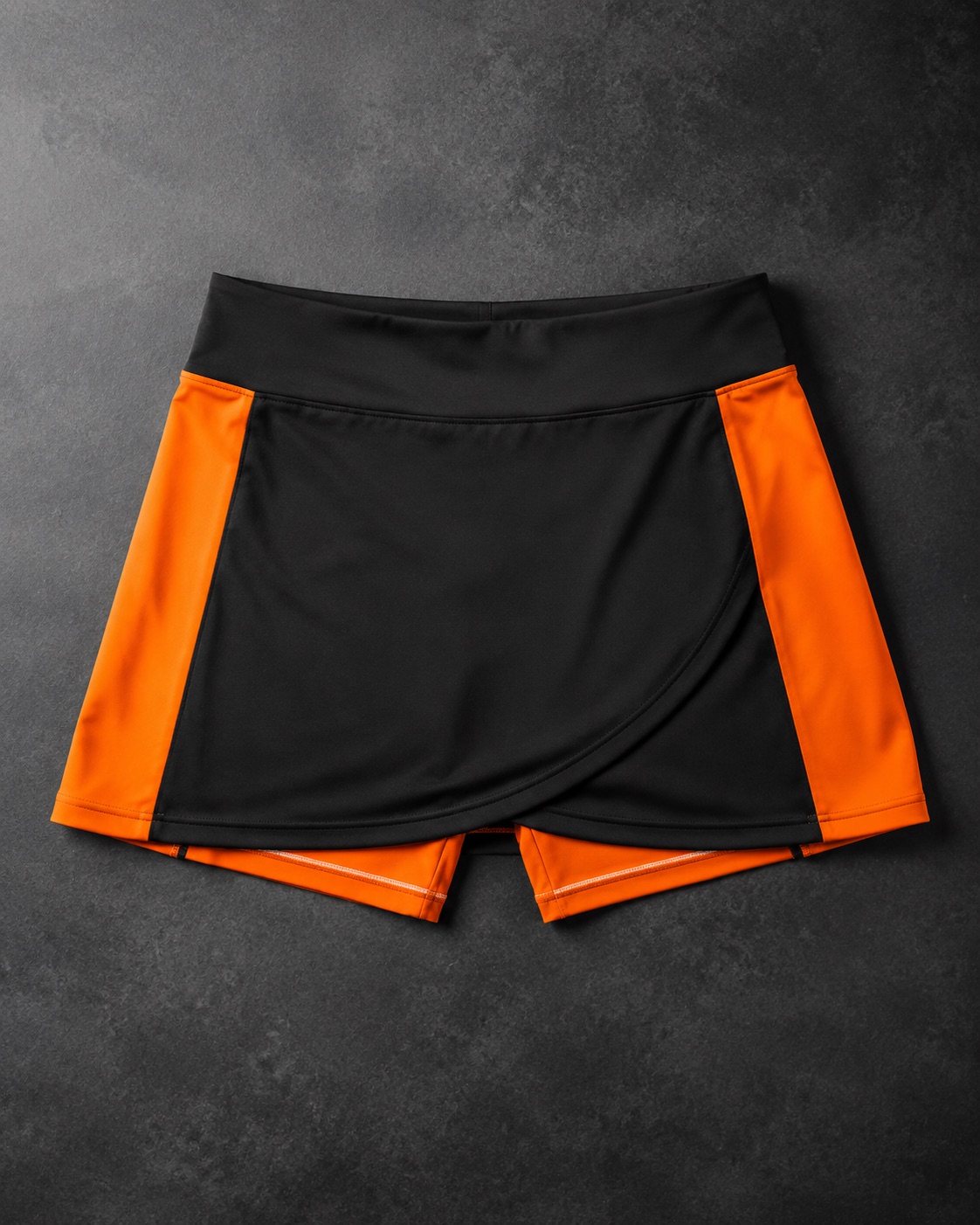 Netball skort with an inner short, flat lay on dark charcoal