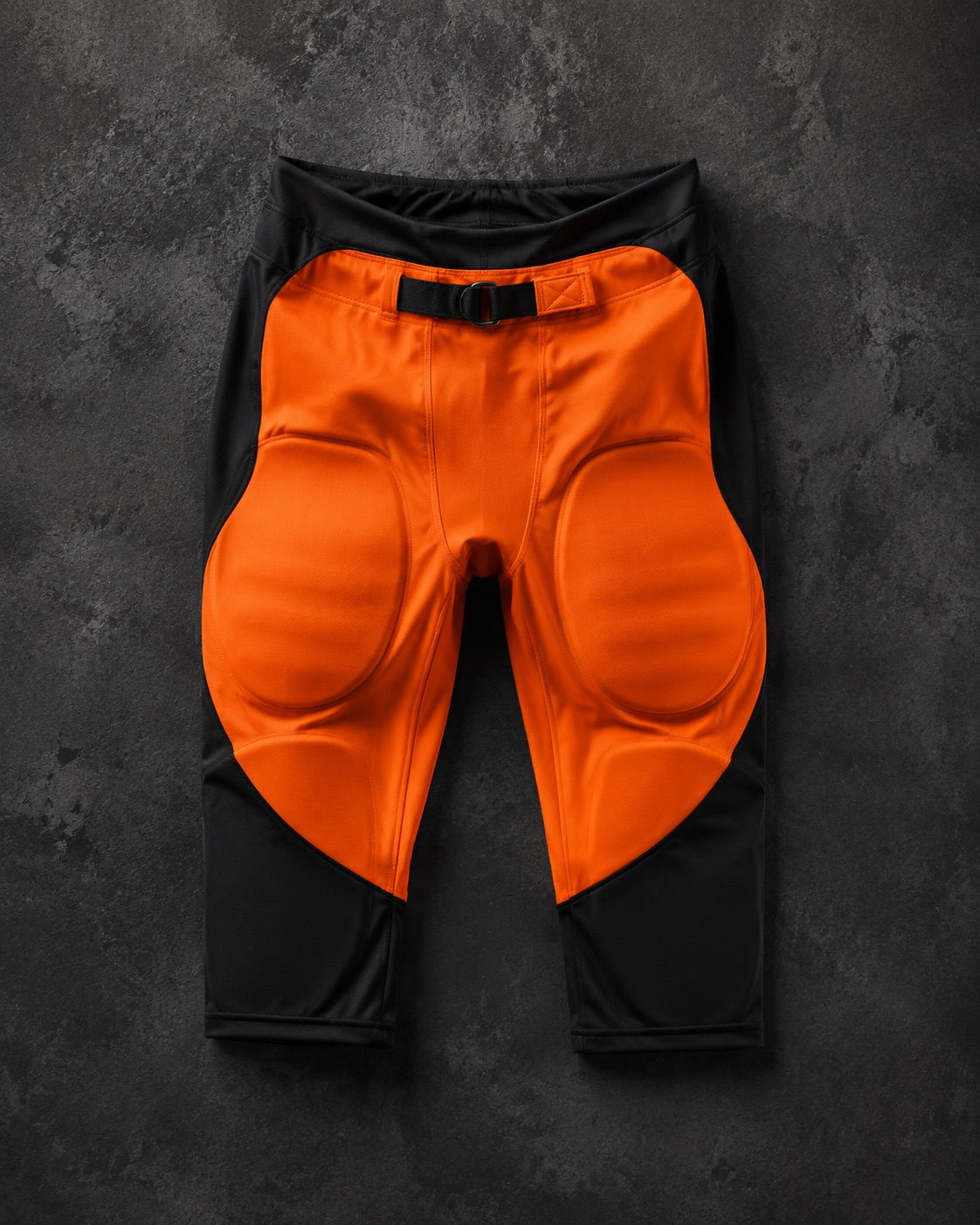 Integrated American football pants with built-in pad pockets, flat lay
