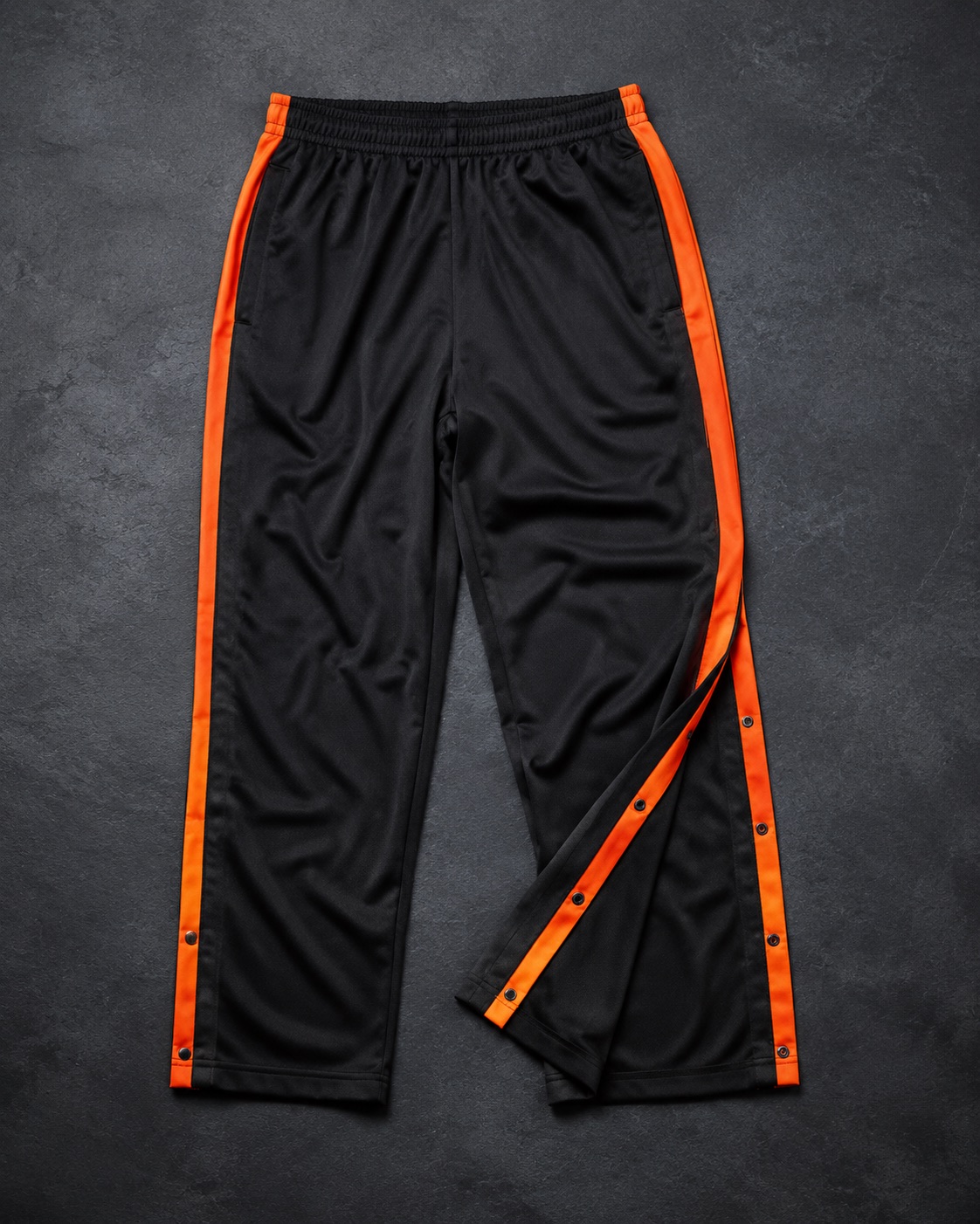 Basketball tear-away warm-up pants with popper leg fastenings, flat lay
