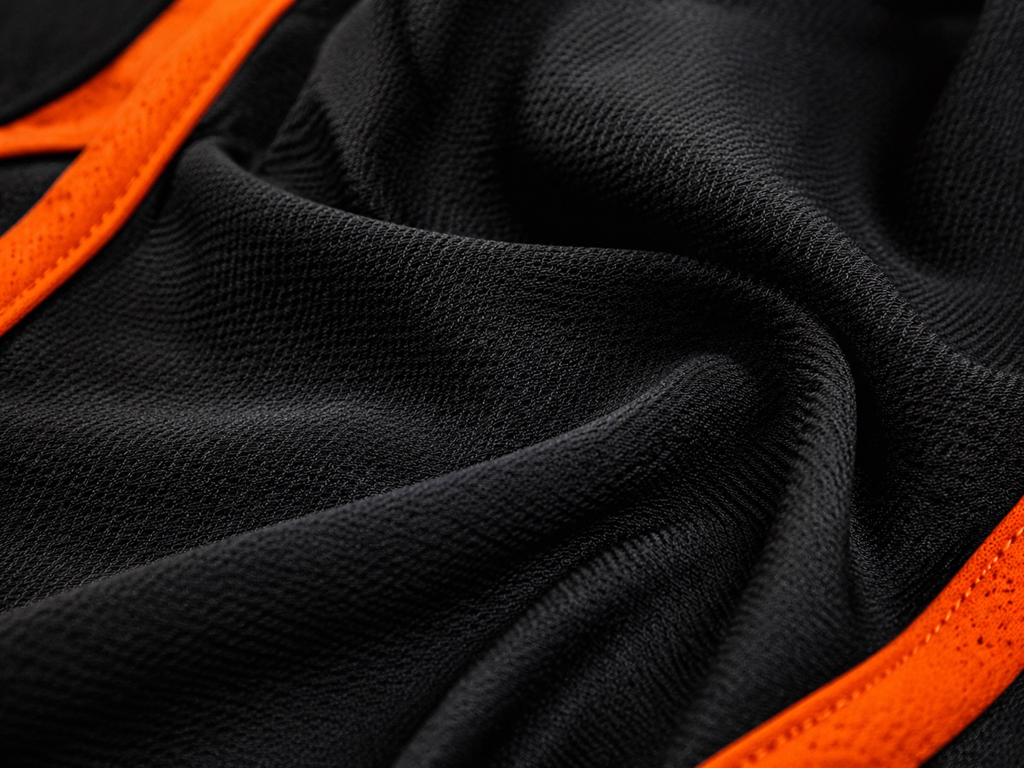 Macro close-up of technical black performance polyester knit