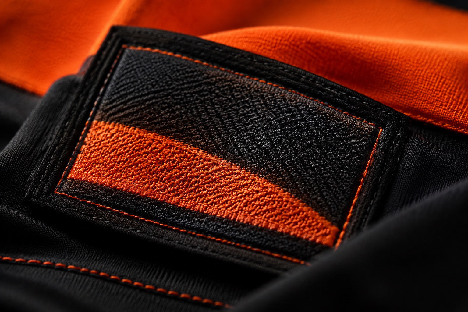 Macro of a woven damask brand label showing the threads forming the logo