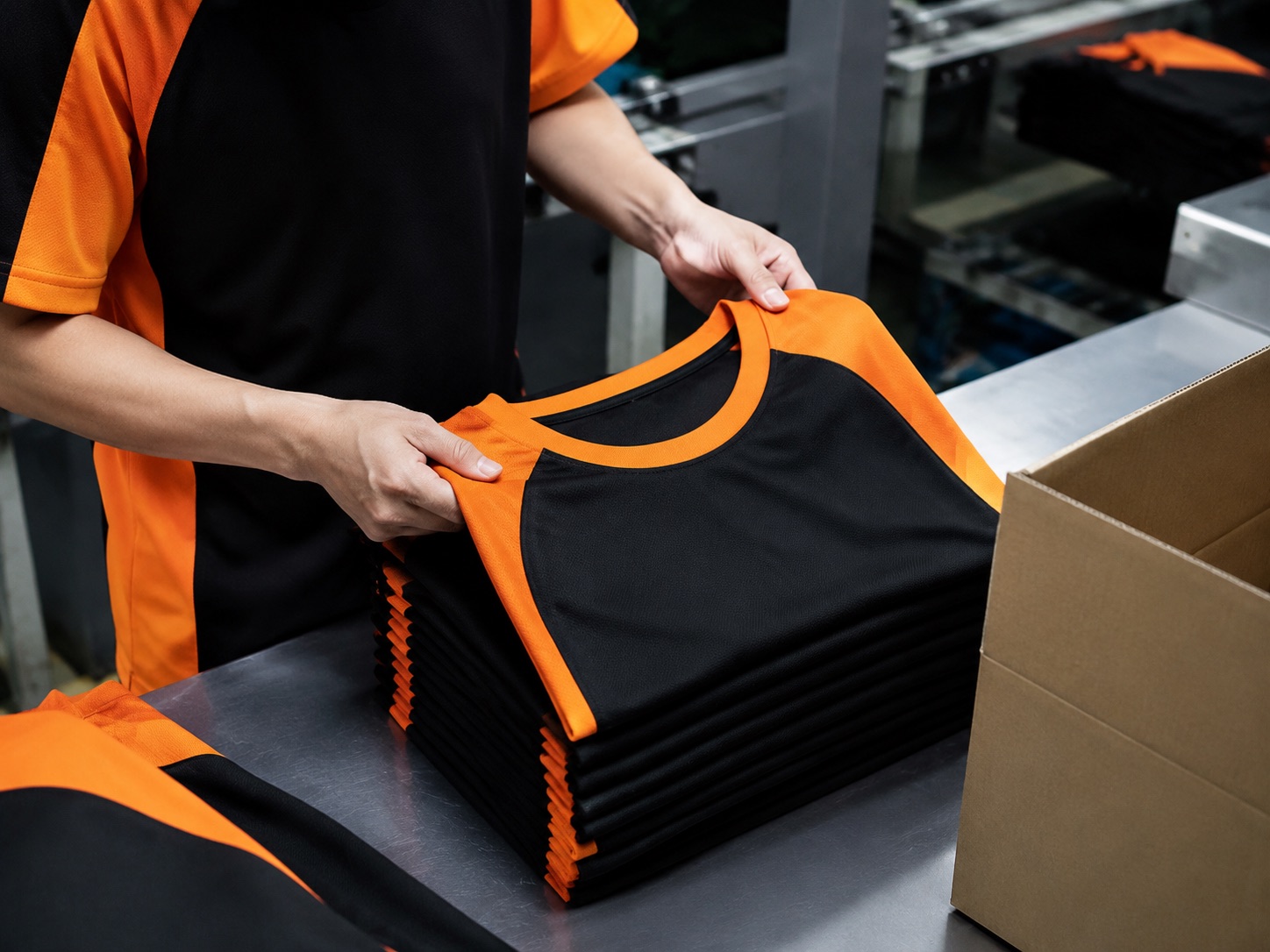Final inspection of folded garments before packing into cartons