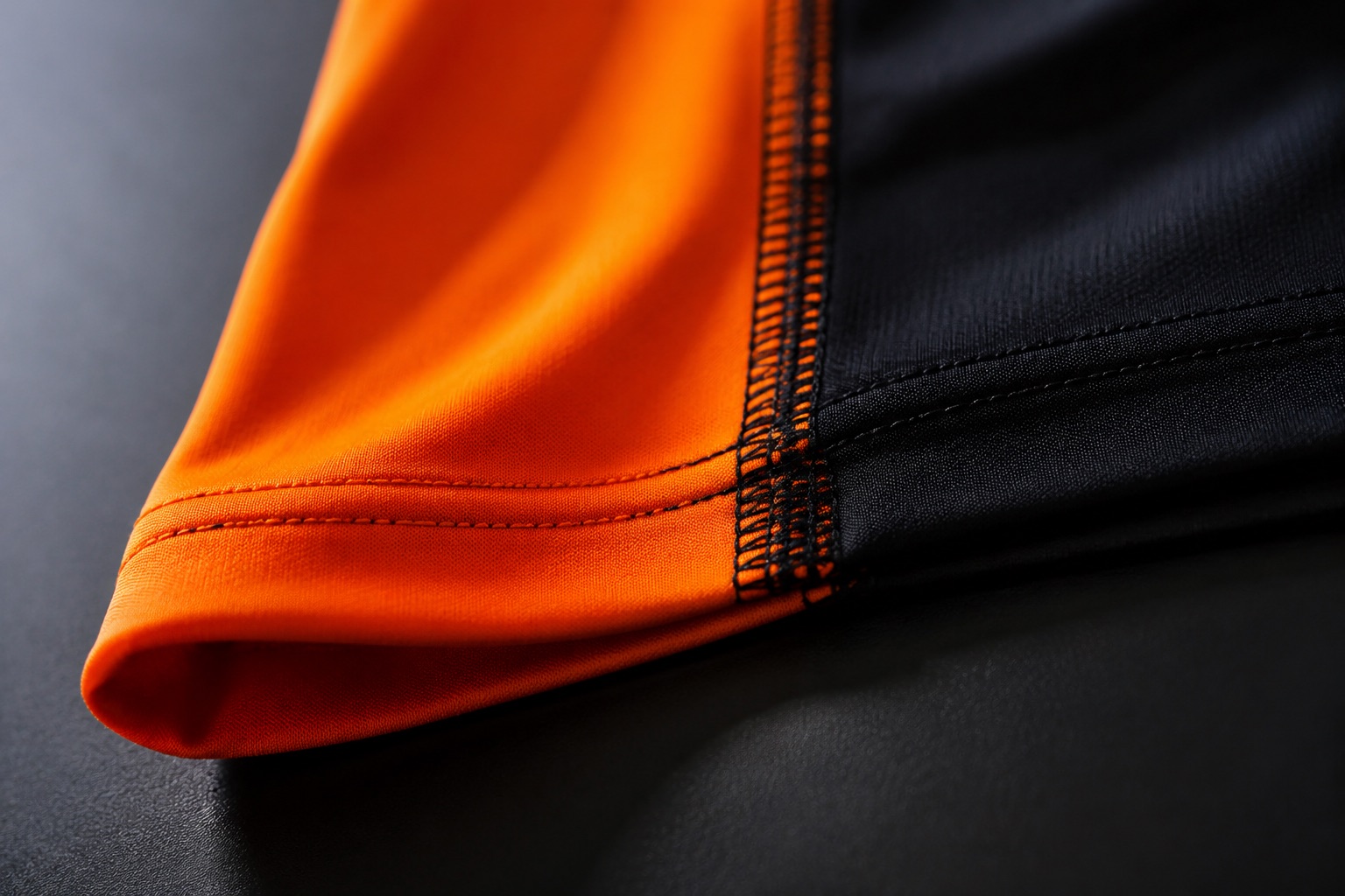 Close detail of a coverstitched stretch hem on a technical garment
