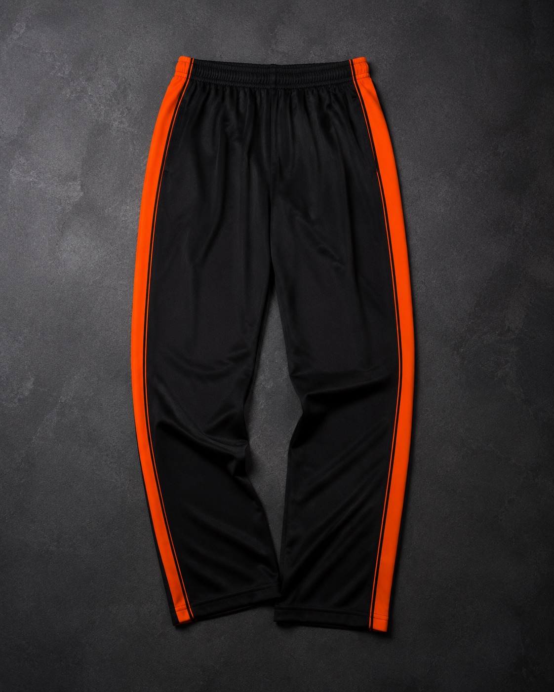 Netball warm-up pants with contrast side piping, flat lay