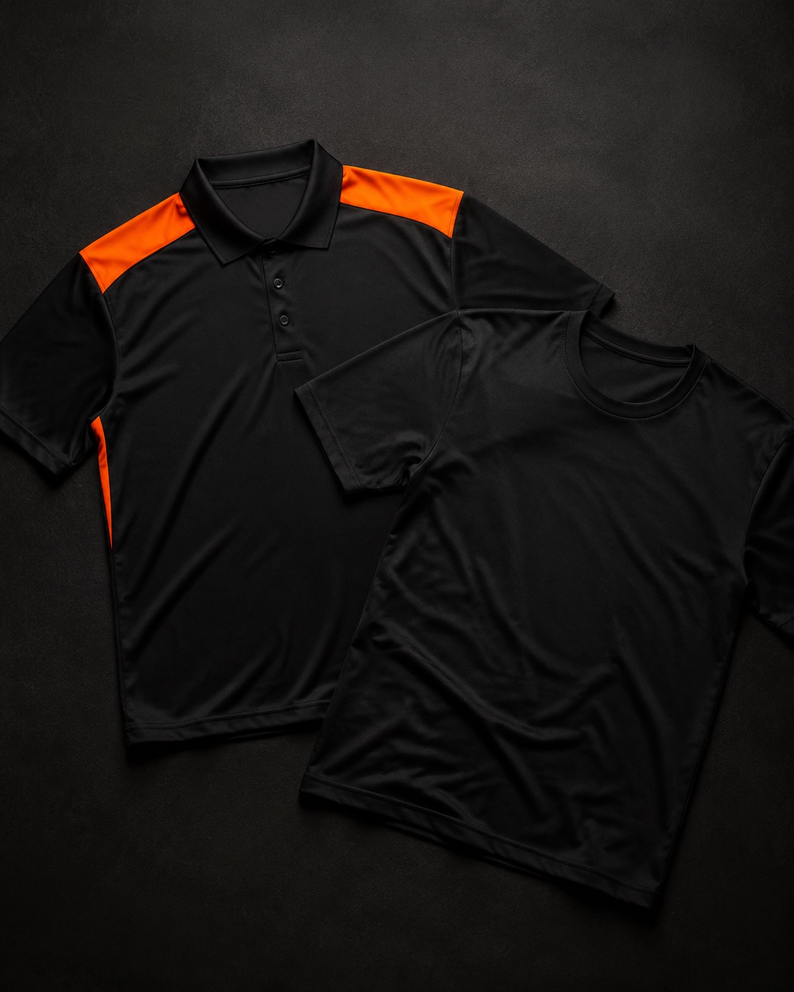Black staff polo shirt with orange shoulder detailing